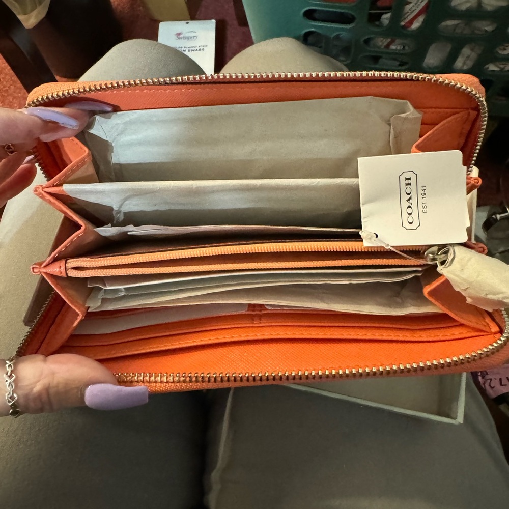 Coach coral and khaki wallet.